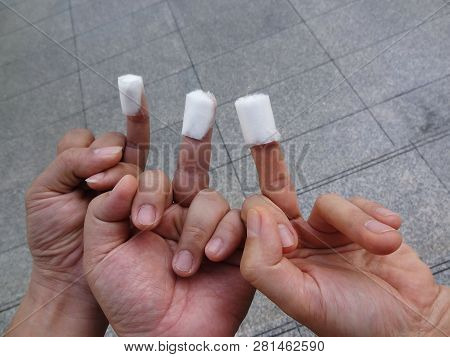 3 Men Hands With One Of Each Fingertip Stick With Medical Cotton Bandage After Have Fingertip Blood 