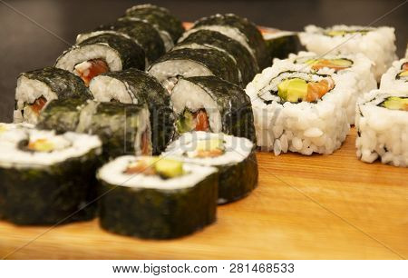 Homemade Sushi Rolls Laid Out On A Wooden Board