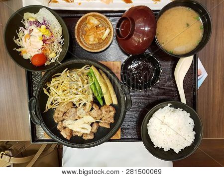 Top View Of Grilled Pork With Bean Sprouts And Baby Corn Topped With Sauce, Salad Vegetable, Kimchi,