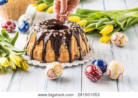 Delicious Holiday Slovak And Czech Cake Babovka With Chocolate Glaze. Female Hands Decorating A Cake
