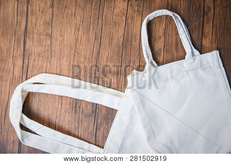 White Tote Canvas Fabric Eco Bag Cloth Shopping Sack On Wooden Background / Zero Waste Use Less Plas