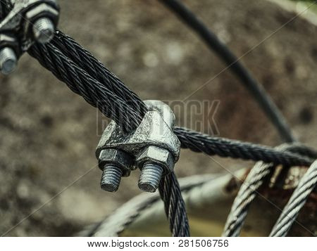 Steel Turnbuckle And Steel  Sling Anchored Safety Net Into Concrete Block.