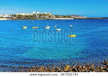 View Of Playa De Las Cucharas Beach In Costa Teguise, Lanzarote, Spain, Turquoise Waters, Boats, Sel
