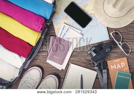 Prepare Accessories And Travel Items, For New Journey, Packing Clothes In Suitcase Bag On Wooden Boa