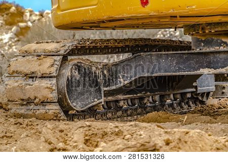 Excavator With Caked Dirt On Its Track Pad In Utah