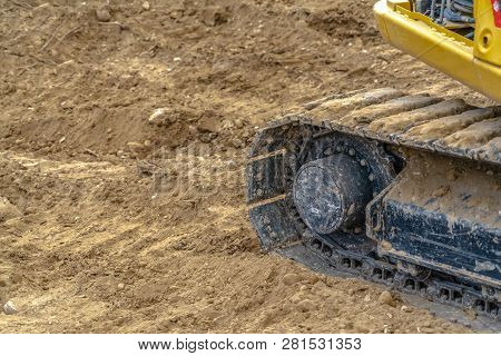 Excavator With Caked Dirt On Its Track Pad In Utah