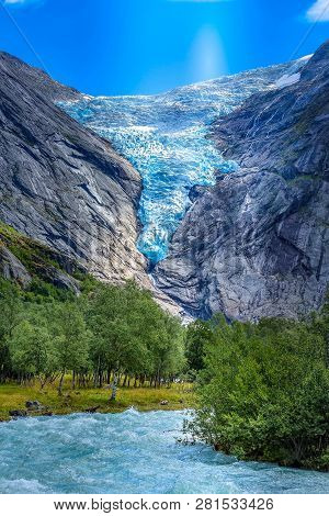 Briksdal Or Briksdalsbreen Glacier With Melting Blue Ice, Norway Nature Landmark And Turquoise River