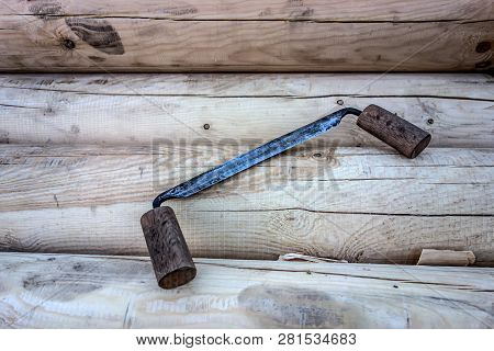 Antique Carpentry Tool Folding Drawknife On The Background Of Wooden Logs