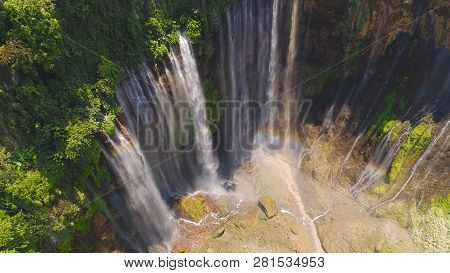 Aerial View Waterfall Coban Sewu In Java, Indonesia. Waterfall In Tropical Forest By Drone Tumpak Se
