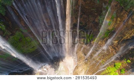 Aerial View Waterfall Coban Sewu In Java, Indonesia. Waterfall In Tropical Forest By Drone Tumpak Se