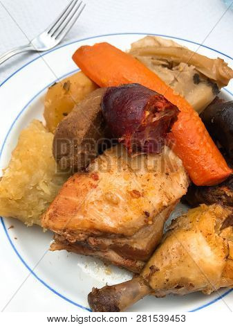 Stew Typical Of The Island Of São Miguel In Azores With Chicken, Chorizo Sausage, Carrot, Cabbage, P