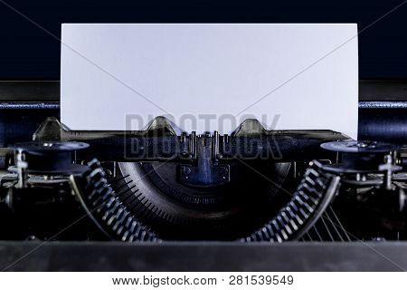 Typewriter On A Black Background With Clear White Page. Horizontal Orintation
