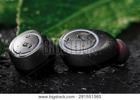 Wireless Earphones Close Up View On Black Stone