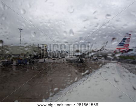 Kauai - April 11, 2018: Looking Out A Rainy Window At A American Airplane At Lihue Airport, Kauai, H