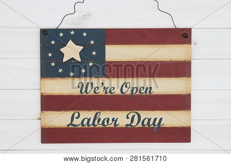 We Are Open Labor Day Text On A Retro Wood American Stars And Strip Flag Sign On Weathered Wood