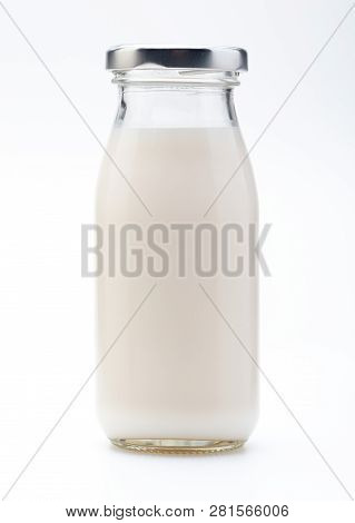 Milk In Glass Bottle. With Cap. Isolated On White Background.
