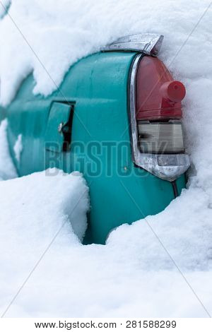 Old Soviet Car Volga. Turquoise Retro Car Covered With Snow. Gaz-21 On The Street In Winter.