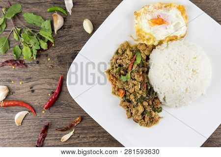 Spicy Thai Basil With Crispy Chicken And Egg (pad Krapow Gai) On Table . It Is A Very Delicious Thai