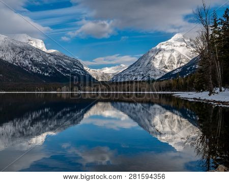A Crisp January Day On Lake Mcdonald Yeilds Almost No Ripple In The Reflection.