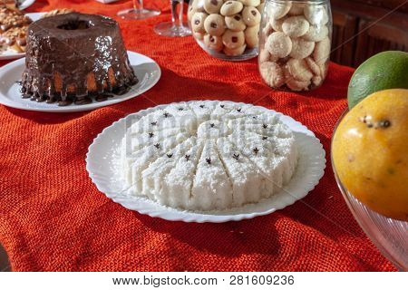 Brazilian traditional dessert: sweet couscous (tapioca) pudding (cuscuz doce) with coconut, breakfast 