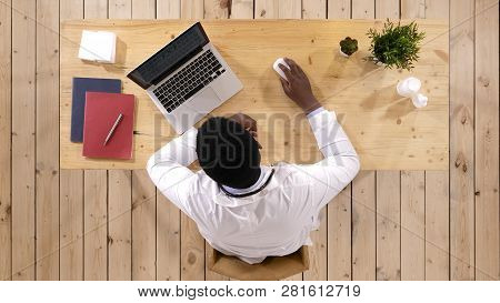 Concentrated African American Male Doctor Working In Medical Office.