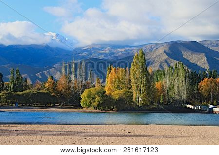 Landscape With Lake Mountains And Trees And A Bit Of Send. Beautiful Weather And Sunny Day And Blue 