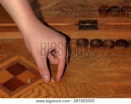 Human Hand Takes Dice In Backgammon Game