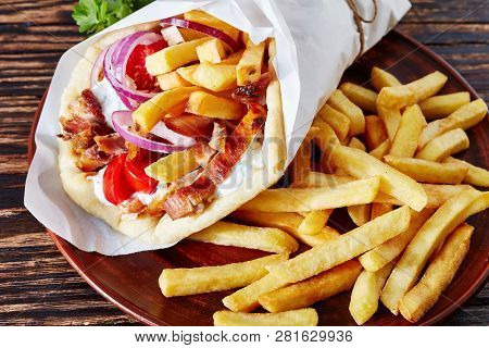 Greek Souvlaki, Pita Ma Gyro With Chicken Meat, Vegetables, French Fries On A Brown Plate On A Woode