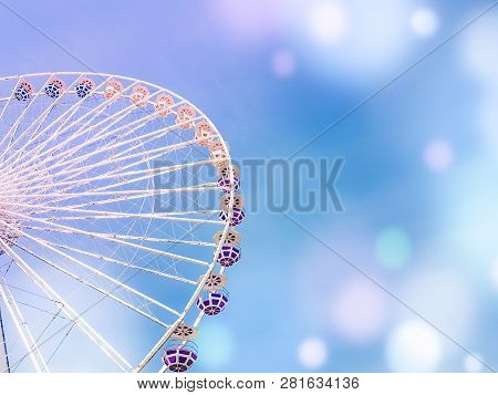 Ferris Wheel On The Background Of Blue Sky With Colorful Bright Circles