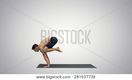 Handsome Man Doing Yoga Asanas On Gradient Background.