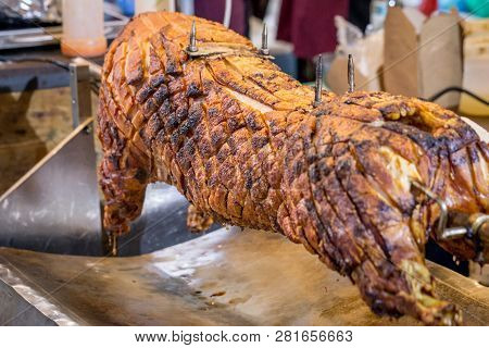 A Spit Roasted Pig On A Market Stall