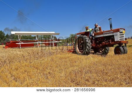 Rollag, Minnesota, September 1, 2018: An Old International 460 Tractor And Swather Participates In A