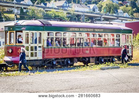 Astoria, Oregon - October 3, 2017: Astoria Riverfront Trolley Taking Tourists On A Tour Around Downt