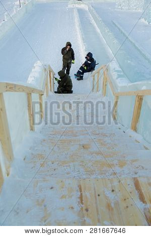 Three Workers At The Installation Of The Ice Town