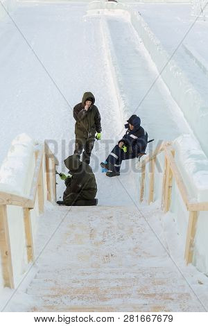Three Workers At The Installation Of The Ice Town