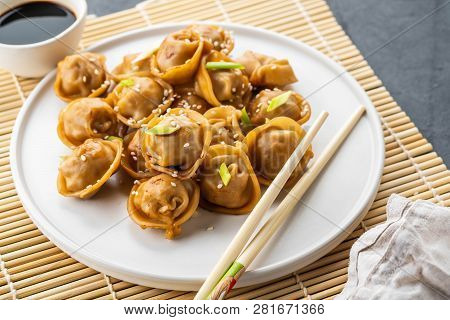 Home Made Chinese And Korean Dumplings Served On The Traditional Steamer And Bamboo Mat Decorated Wi