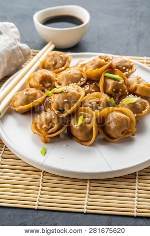 Home Made Chinese And Korean Dumplings Served On The Traditional Steamer And Bamboo Mat Decorated Wi