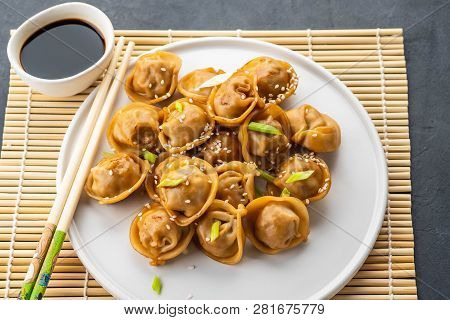 Home Made Chinese And Korean Dumplings Served On The Traditional Steamer And Bamboo Mat Decorated Wi