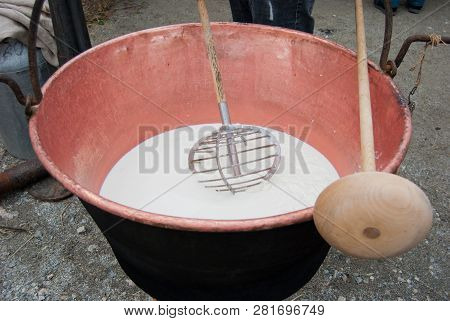 Big Pot Where A Cheesemaker Are Making Cheese From The Milk