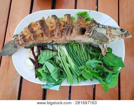 Thai Food Style, Fried Fish With Fish Sauce On White Ceramic Plate, Pla Tod Num Pla Is Thai Traditio