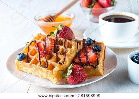 Fresh Homemade Food Of Berry Belgian Waffles With Honey, Chocolate, Strawberry, Blueberry, Maple Syr