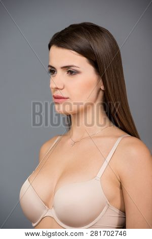 Close Up Portrait Of Beautiful Brunette Women With A Slim Figure In Beige Bra. Model Snaps In The St