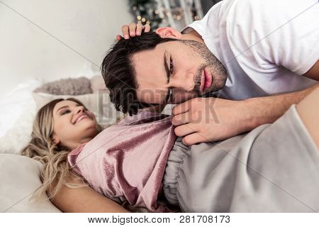 Pretty Blond Long-haired Woman In Beautiful Home Clothes Looking At Her Husband