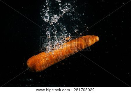 Image Of Long Orange Carrot Falls In Water