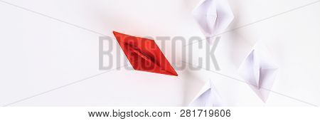 Red Paper Boat Among Other White. Leadership, White Crow, Individuality. Piranhas And A Shark. Not L