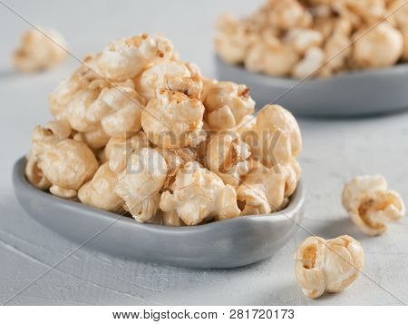 Popcorn In Gray Craft Trendy Plate On Gray Concrete Background. Moovie Background With Copy Space. T