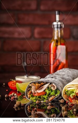 Two Burrito, Black And White Lavash With Chicken, Mushrooms, Salad, Cherry Tomatoes, Lime, And Salsa