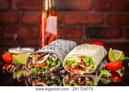 Two Burrito, Black And White Lavash With Chicken, Mushrooms, Salad, Cherry Tomatoes, Lime, And Salsa