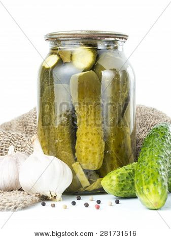 Pickled Cucumbers Isolated. Pickles In Glass Jar With Garlic And Peppercorn Isolated On White Backgr