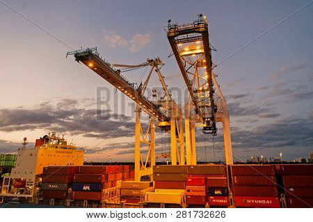 Miami, Usa - March 01, 2016: Cranes And Cargo Containers Stacked In Port. Container Port Or Terminal